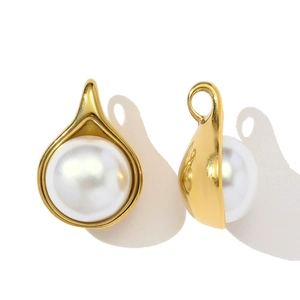 Detailed close-up of a gold teardrop pendant with a white pearl on a clean white backdrop