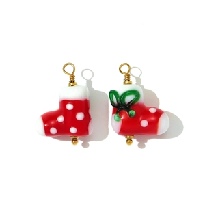 Detail of handmade red Christmas boot charms with white dots and gold wire hooks
