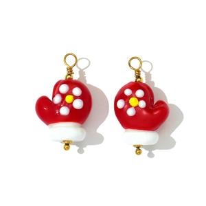 Detail of red flower glove charms with gold loops for DIY Christmas jewelry making