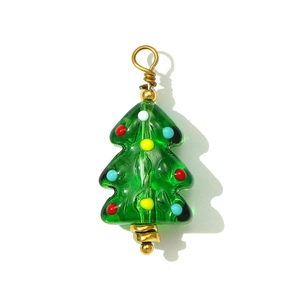 Detailed view of handmade green glass Christmas tree pendant with colorful glass dot accents