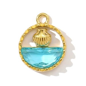 Close-up of golden marine pendant with light blue crystal and detailed metallic shell