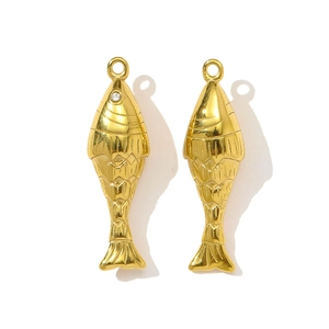 Macro detail of golden fish pendants with scale texture and small rhinestone eye details