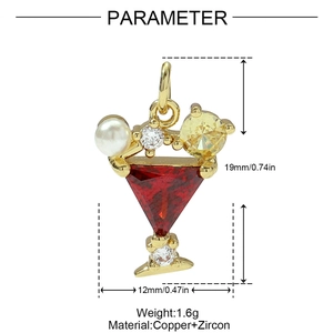 Detailed view of cocktail glass pendant with red gem, pearl, and gold finish