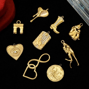 3D gold-plated heart and boot charms with zircon inlay on black velvet background