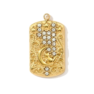 Macro detail of golden 3D cat and crescent moon pendant with sparkling cubic zirconia