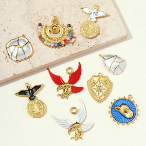 Various vintage gold-plated eagle pendants and western style jewelry charms with enamel inlay