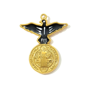 Detail of Saint Benedict medal pendant with golden finish and eagle design