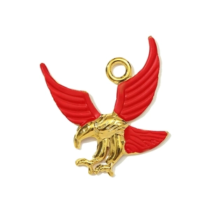 Macro shot of gold stainless steel eagle pendant with red enamel wings and circular ring