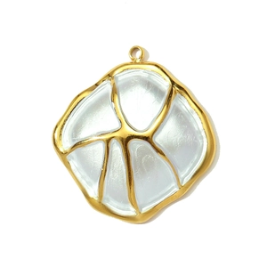 Detailed view of fan-shaped pendant with golden metal trim and white mother-of-pearl inlay