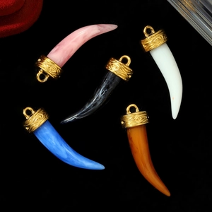 Five assorted horn-shaped faux stone pendants with antique gold-plated embossed caps