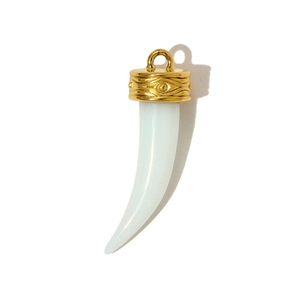 Close-up of horn-shaped pendant with ivory finish and golden evil eye engraved cap