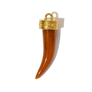 Detail of amber resin horn pendant with embossed gold-tone metal cap on white background