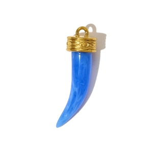 Detail view of blue marble resin cornicello pendant with golden evil eye engraved cap
