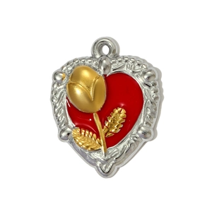 Detail of a heart-shaped pendant with red enamel, gold rose motif and silver beaded edges