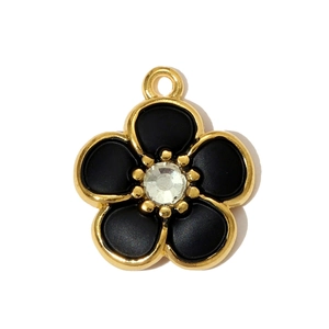 Detail of flower charm with black enamel petals and a central sparkling rhinestone