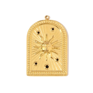 Macro detail of a vintage arch-shaped gold sun pendant with black enamel inlay
