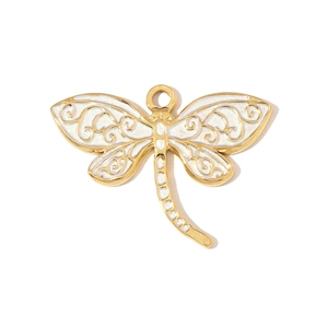 Detailed view of a golden dragonfly pendant with white enamel wings and filigree patterns