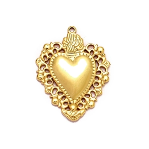 Golden heart pendant with ornate scrollwork and angel relief in polished finish