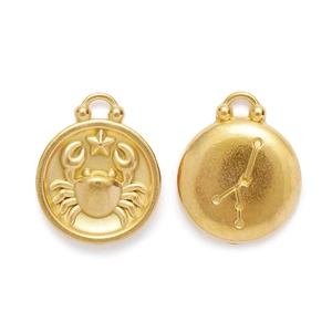 Close-up of golden Cancer zodiac pendant with crab relief and constellation chart details