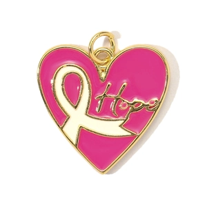Macro shot of pink enamel heart charm with white ribbon and Hope engraving in gold