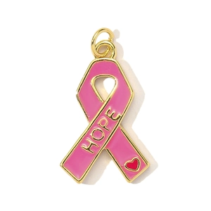 Pink ribbon hope charm with gold metal edges and a small red heart on white background
