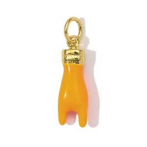 Macro shot of an orange enamel claw pendant with a polished gold-plated metal ring