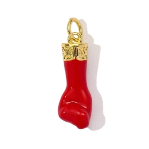 Detailed view of red Mano Figa fist pendant with ornate golden filigree cap and loop