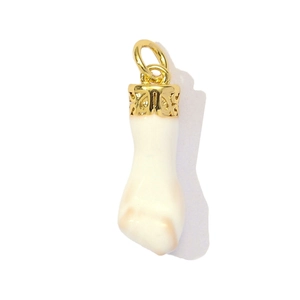 Vintage golden hollow patterned pendant with cream fist carving on white background