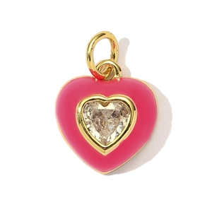 Detailed view of pink enamel heart pendant with central zircon in gold plated frame
