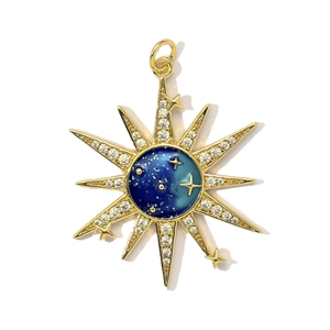 Golden sunburst pendant with sparkling cubic zirconia and deep blue starry sky center