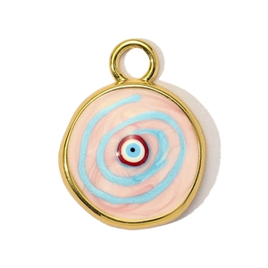 Macro detail of a round pink enamel evil eye pendant with gold plating and spiral texture