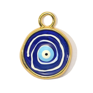 Detail view of round golden evil eye pendant with blue enamel spirals and top loop