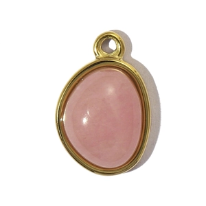 Macro view of teardrop pink natural stone pendant with gold titanium steel frame