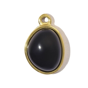 Close-up of teardrop black stone pendant with golden stainless steel frame