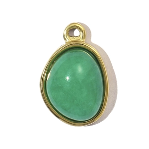 Detailed close-up of a green gemstone pendant with polished gold stainless steel frame