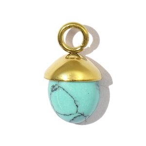 Detail of acorn pendant with gold metal cap and natural turquoise stone texture