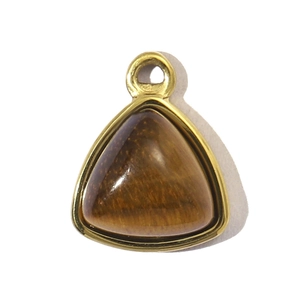 Macro detail of triangle tiger eye stone pendant with golden stainless steel frame