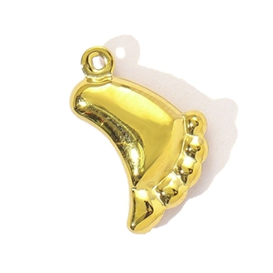 Detailed close-up of a gold dumpling-shaped pendant in polished stainless steel