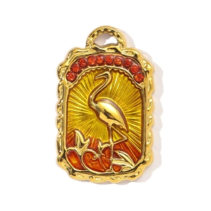 Detail of flamingo enamel pendant with orange rhinestones and sunburst texture
