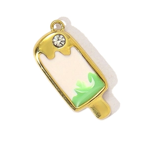 Detail of ice cream charm in gold plating with white and green enamel and crystal