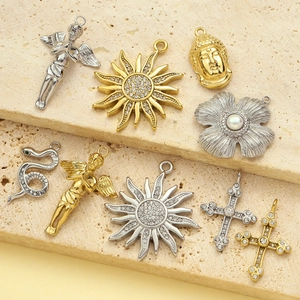 Vintage stainless steel pendants featuring angel, sun, and rhinestone cross designs