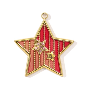 Macro view of gold stainless steel star pendant with red resin inlay and pink crystals