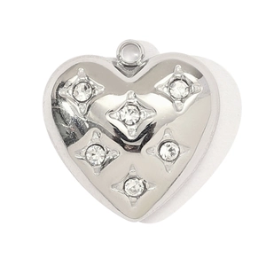 Macro detail of heart-shaped stainless steel pendant with five star-set crystals