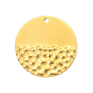 Detail of a vintage gold titanium steel pendant with unique hammered texture finish