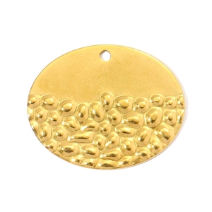Close-up of golden oval stainless steel pendant with smooth top and embossed grain texture