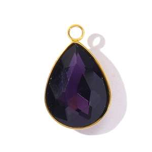 Close-up of faceted purple teardrop crystal pendant with gold bezel setting
