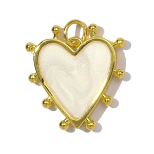 Detailed view of heart-shaped gold-plated copper pendant with white enamel inlay