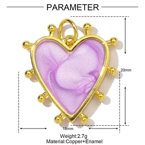 Detail of heart-shaped copper pendant with purple enamel and gold beaded edges