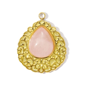 Detail of pink crystal teardrop pendant in vintage gold filigree stainless steel frame