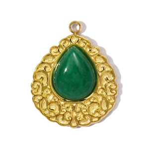 Close-up of vintage malachite water drop pendant with golden filigree metal frame